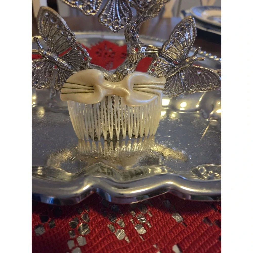 T.Z. Inc. 1981 vintage hair comb is made of faux mother-of-pearl cellulose...